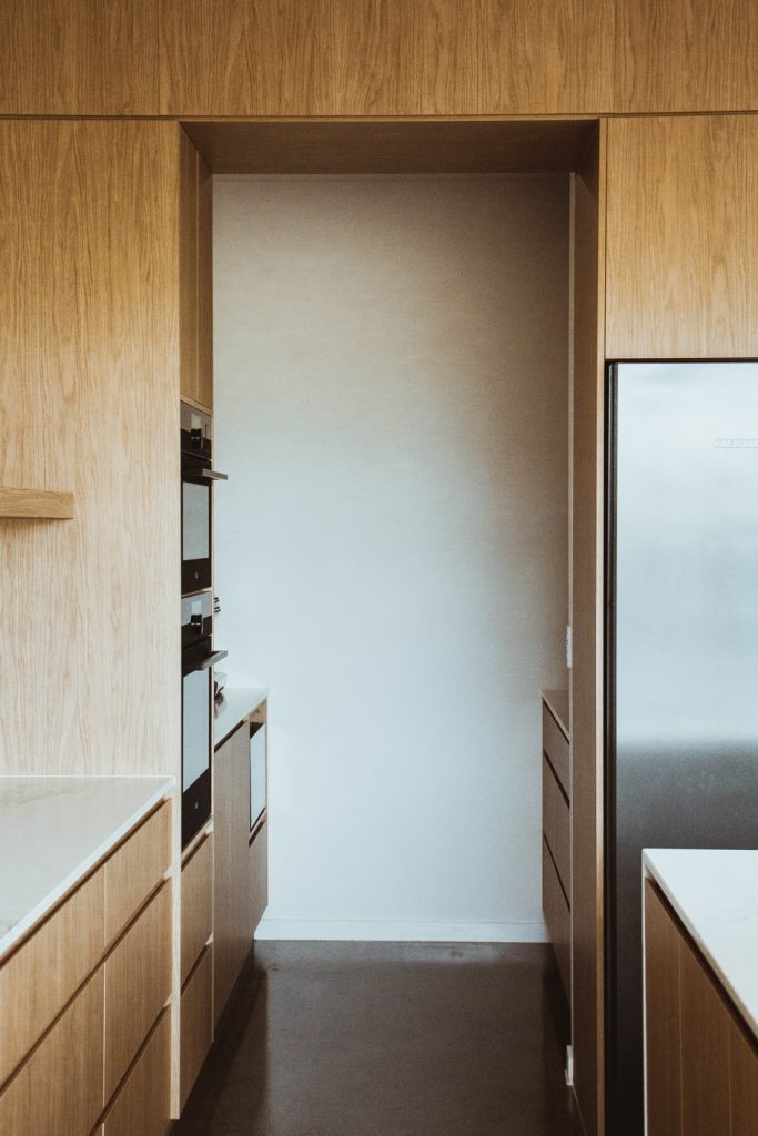 Modern-Compact-Suburban-Home-in-Mitchelton-by-Flourish-Architecture-kitchen-walkway-or-hallway