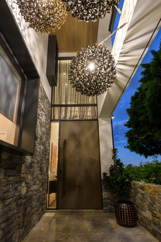 Luxury-home-renovation-by-Hampton-Homes-Australia-entrance-door-with-hanging-light-decorations