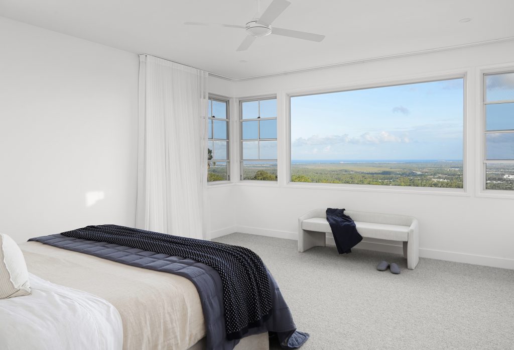 Coastal-style-home-in-sunshine-coast-hinterland-by-Kate-Cooper-interiors-masters-bedroom-with-view-of-the-ocean