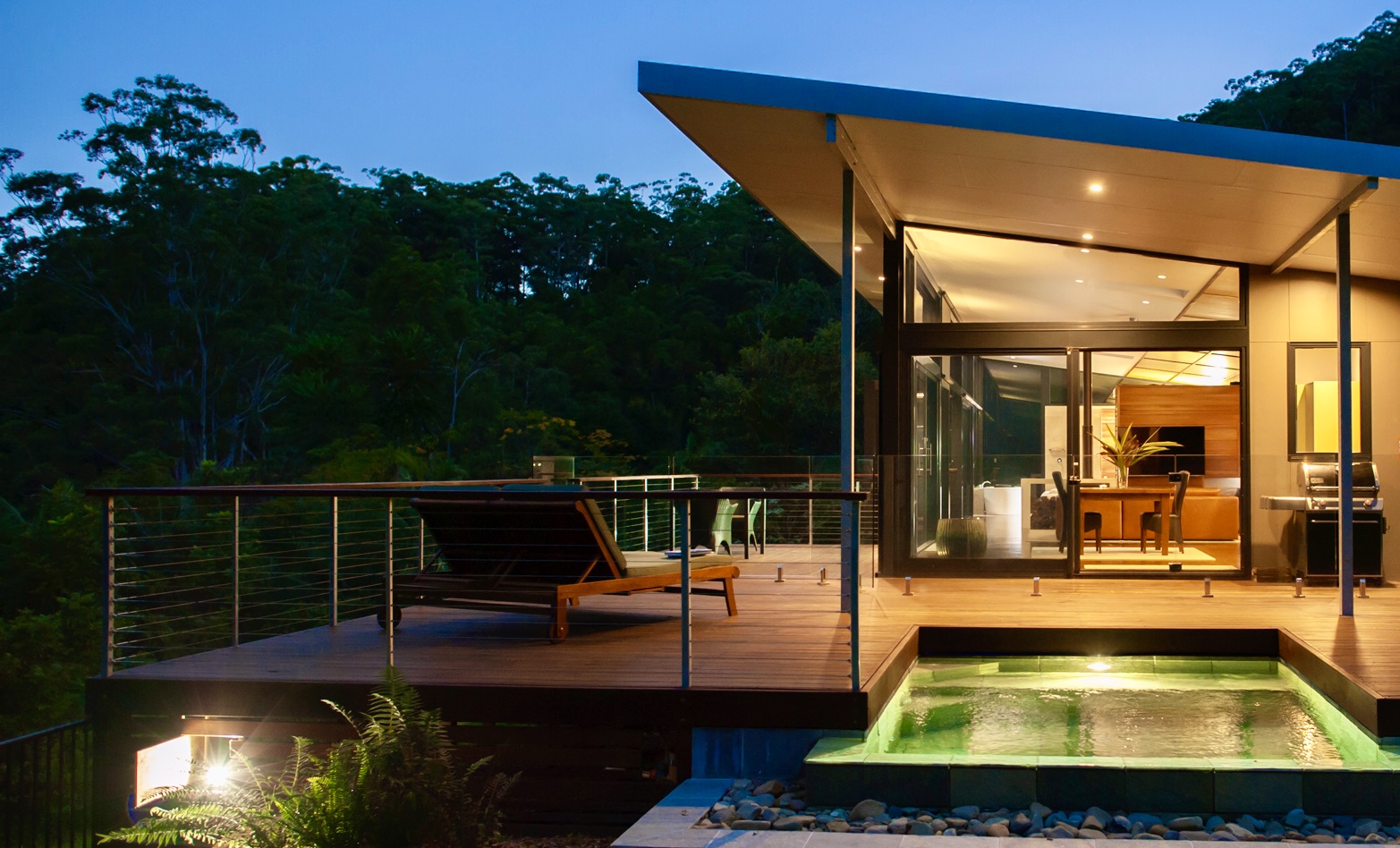 Byron Bay luxury lodge in the rainforest hinterland set high with mountain views at dusk from the pool deck.